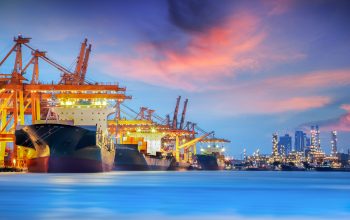 Container Cargo freight ship with working crane bridge in shipyard at dusk for Logistic Import Export background